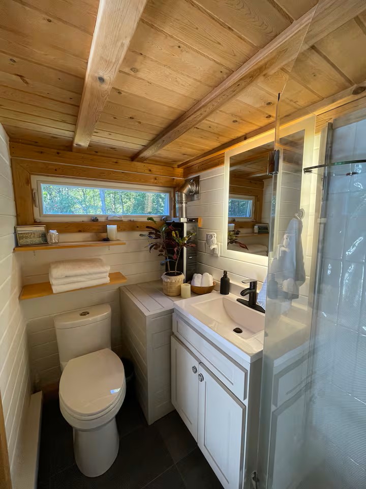 Clean bathroom with rainfall shower and cedar tongue and groove ceiling